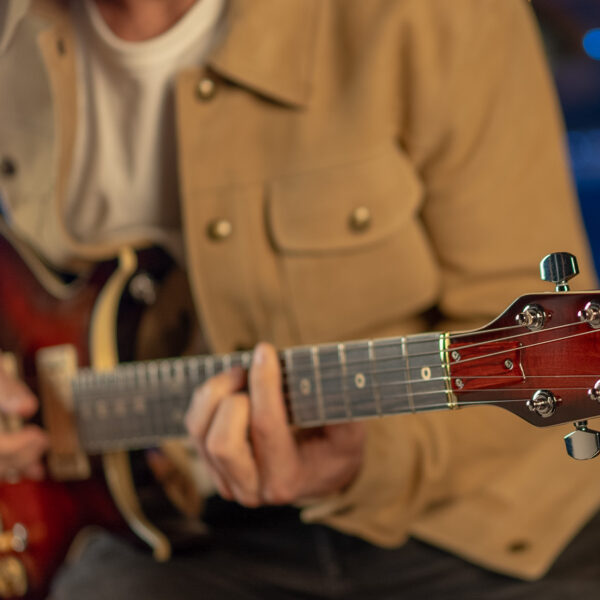 Washburn American Hawk '78 guitar strummed by guitar player